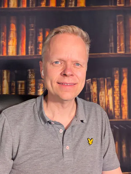 Chris Baird at his desk in front of a bookshelf